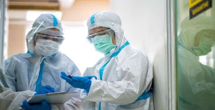 Asian doctor checking coronavirus or covid-19 infected patient in quarantine room